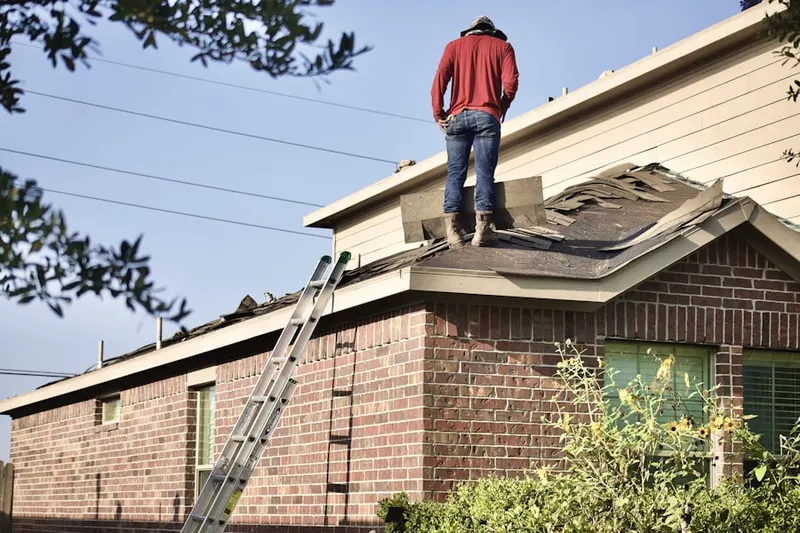 Professional roofer working on a residential roof in Elmwood